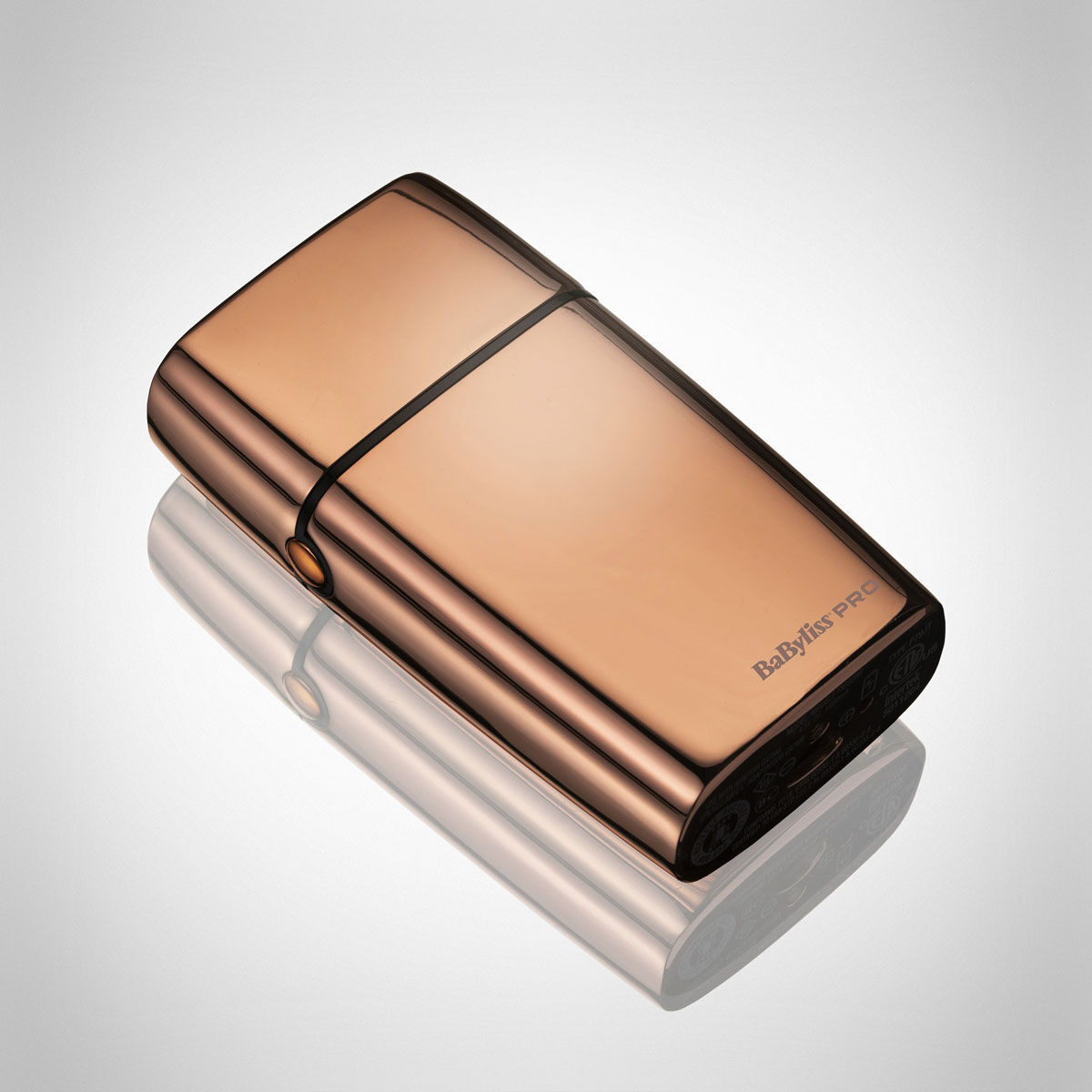 Cordless Rose Gold Foil Shaver laying down with cap on